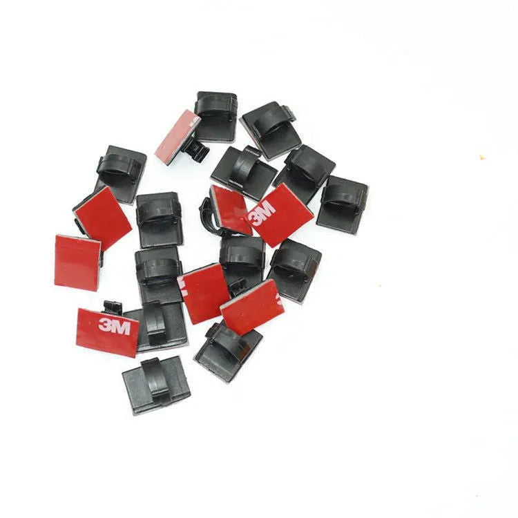 Black and white self-adhesive plastic buckle clamps for organising flat automotive wiring cables
