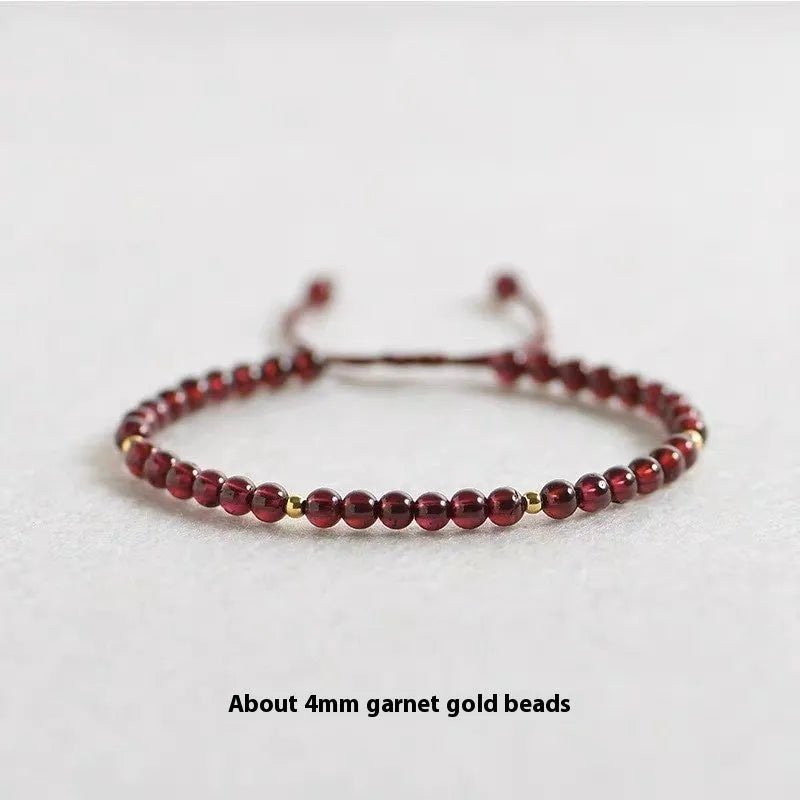 Hand-woven red rope garnet bracelet on a wrist, showing flexible wire and new Chinese style.