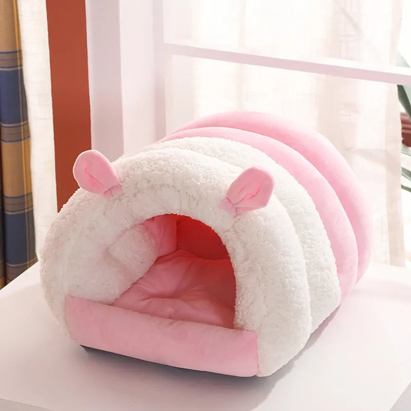 Blue closed hooded cat nest bed showing padded interior and washable cover.