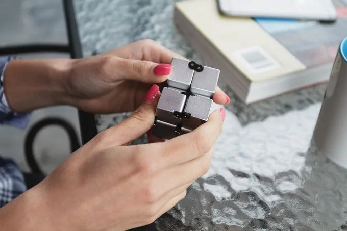 Zinc alloy infinity cube fidget toy showing rotating black cubes in 4cm metal construction