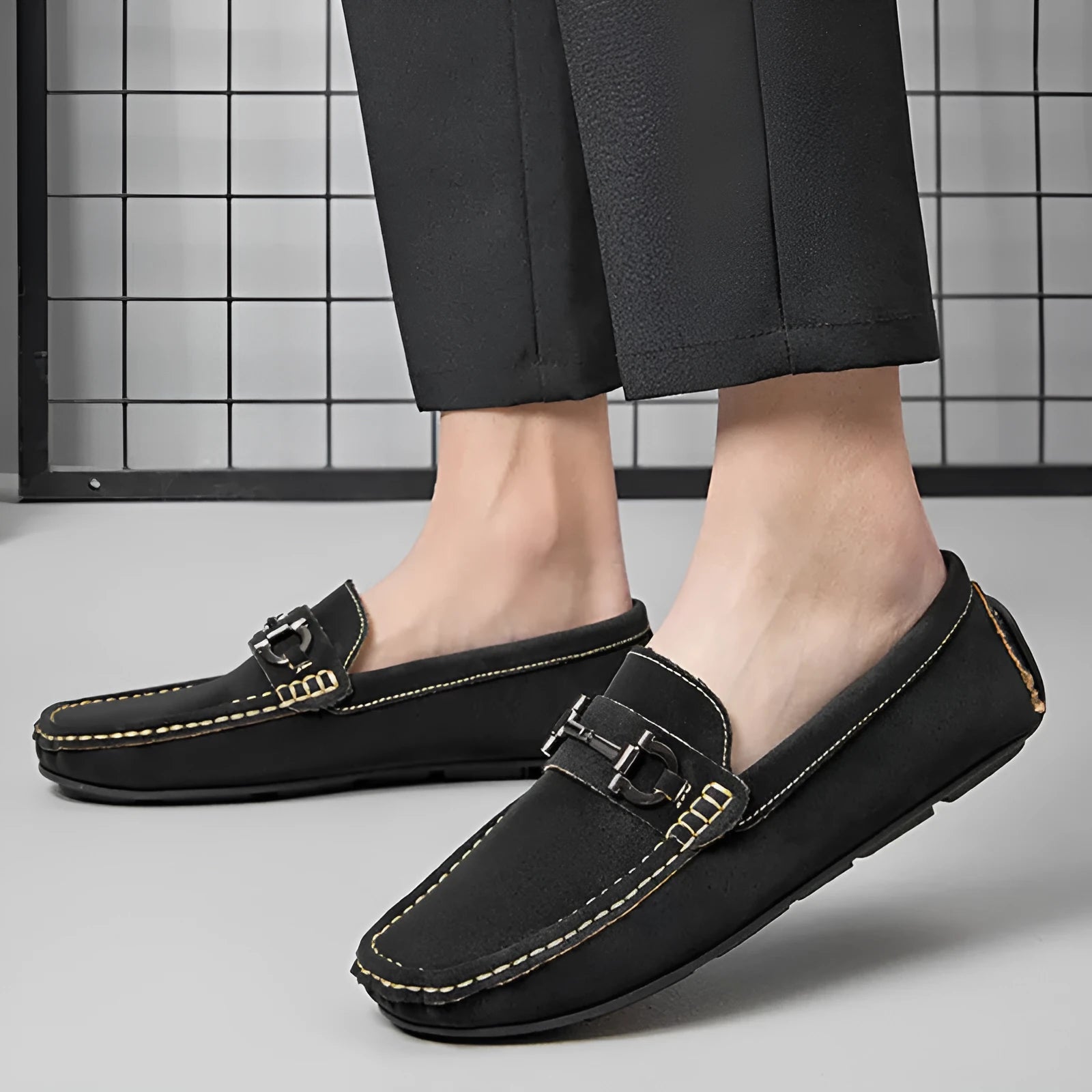 Men's brown leather slip-on loafers with a round toe and rubber sole.