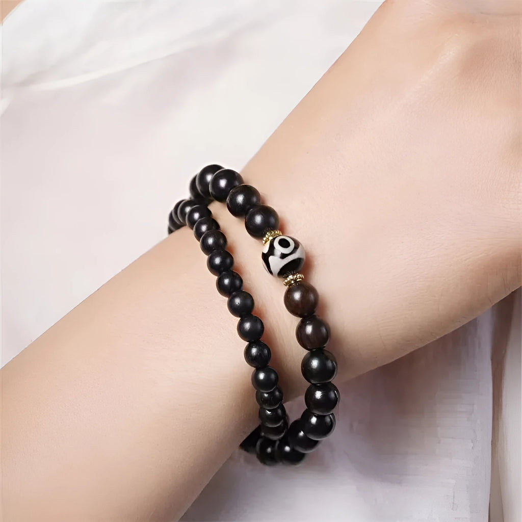 Ebony wood Tibetan prayer bead bracelet showing 8mm diameter and natural wood grain