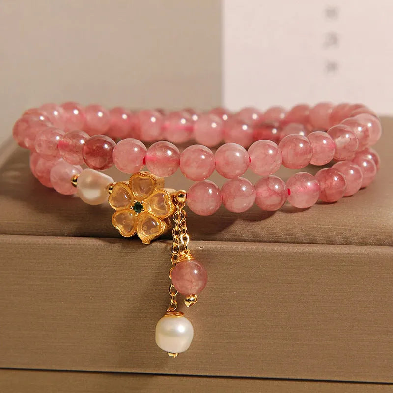 Women's double ring bracelet with strawberry quartz four-leaf clover charm and alloy inlay detailing