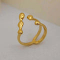 Brass spherical ring with circular design elements in gold or silver finish