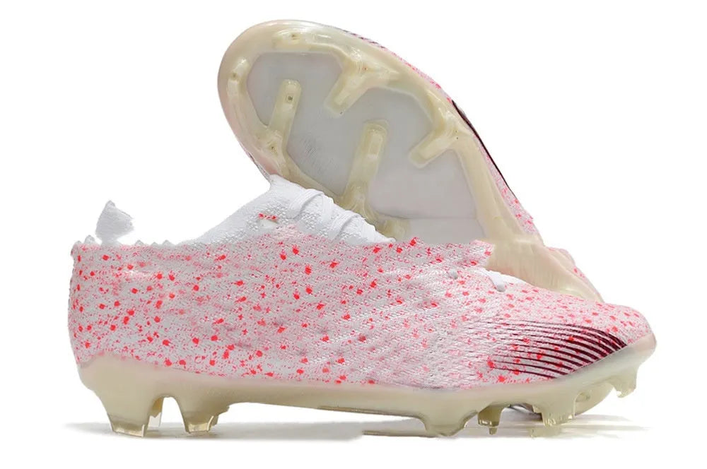 Men's black football boots with knit upper, lace-up front, and rubber FG studded sole.
