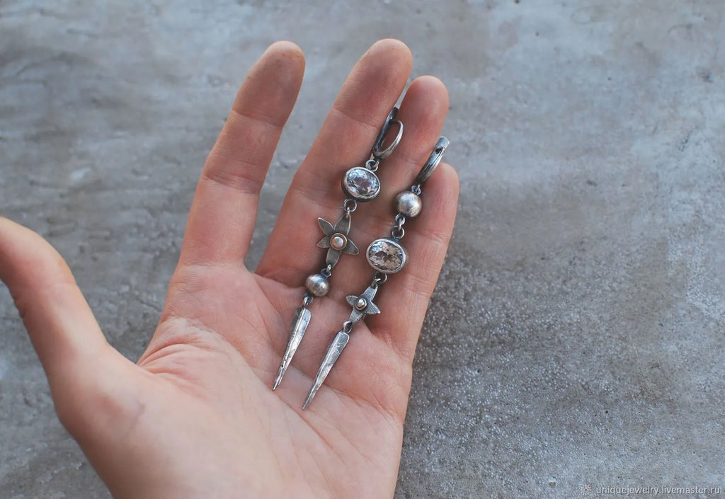 Geometric long XINGX pendant earrings in antique silver with rhinestone details on alloy.