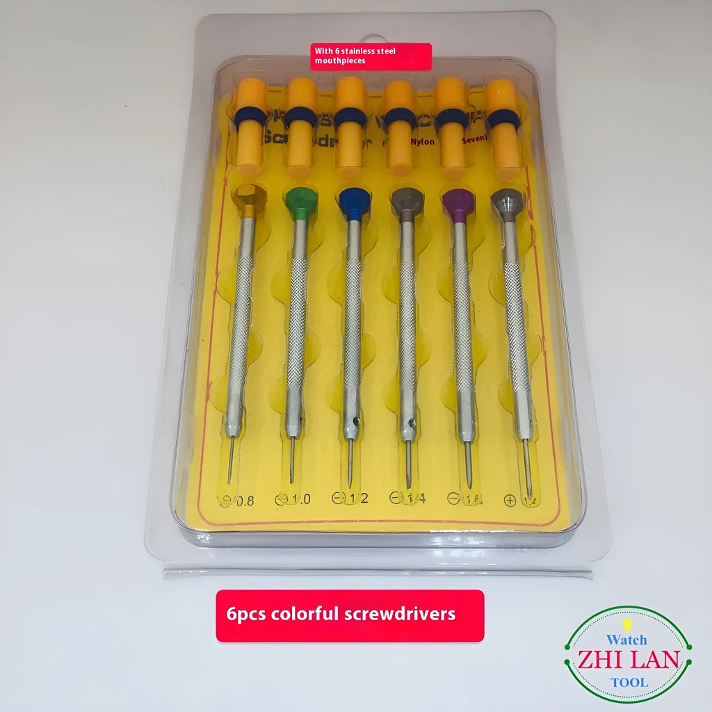 Six colour-coded watch repair screwdrivers with aluminium and copper handles laid out on a surface.
