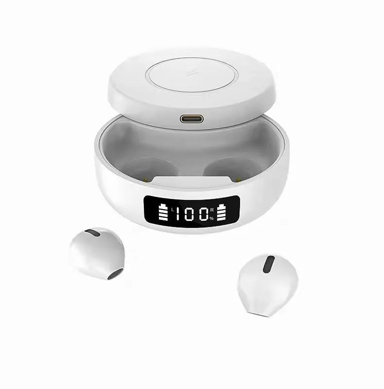 Mini black and white semi-in-ear wireless headphones with their wireless charging case on a table.