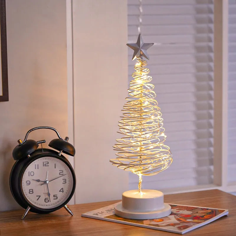Wrought iron LED Christmas tree light with spiral design and warm white illumination on table