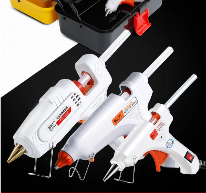 White electric hot glue gun with metal stand and safety switch.