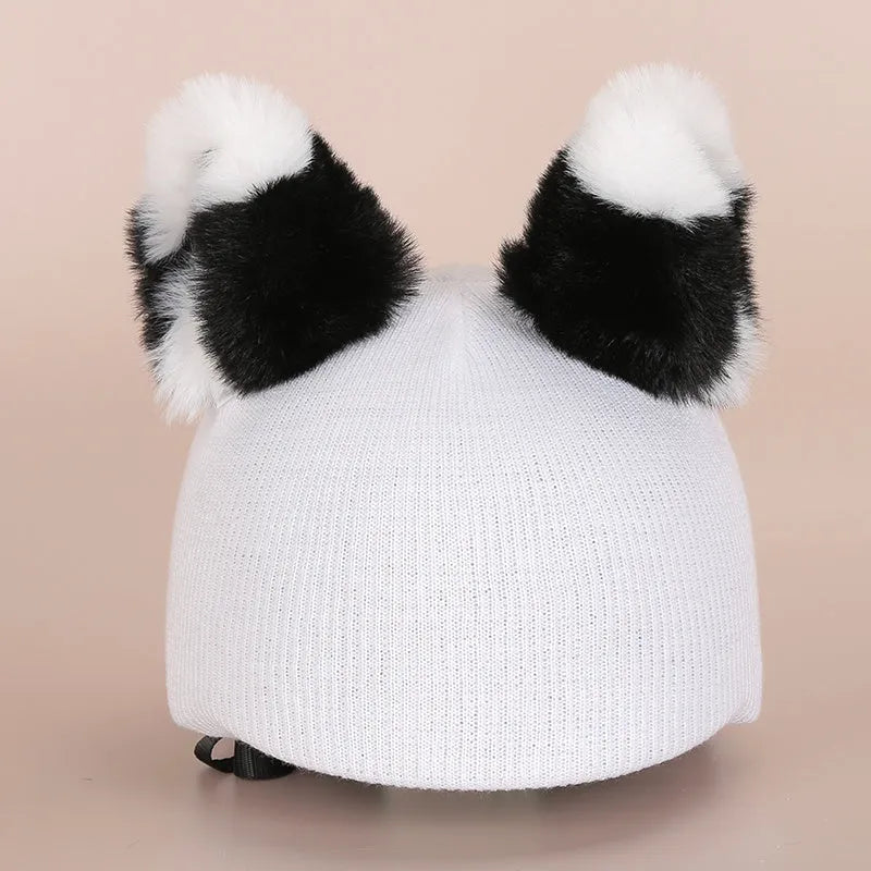 Plush fabric cute cartoon decoration hat placed on a ski helmet.