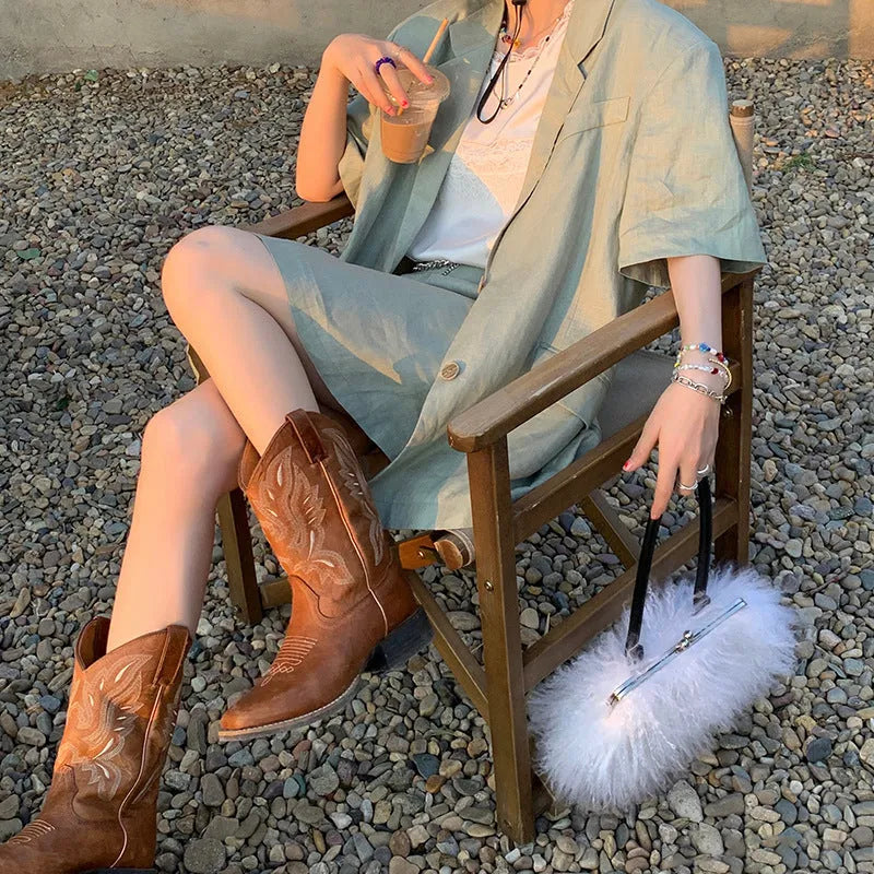 Brown women's mid-calf Martin boots with embroidery and a square low heel.