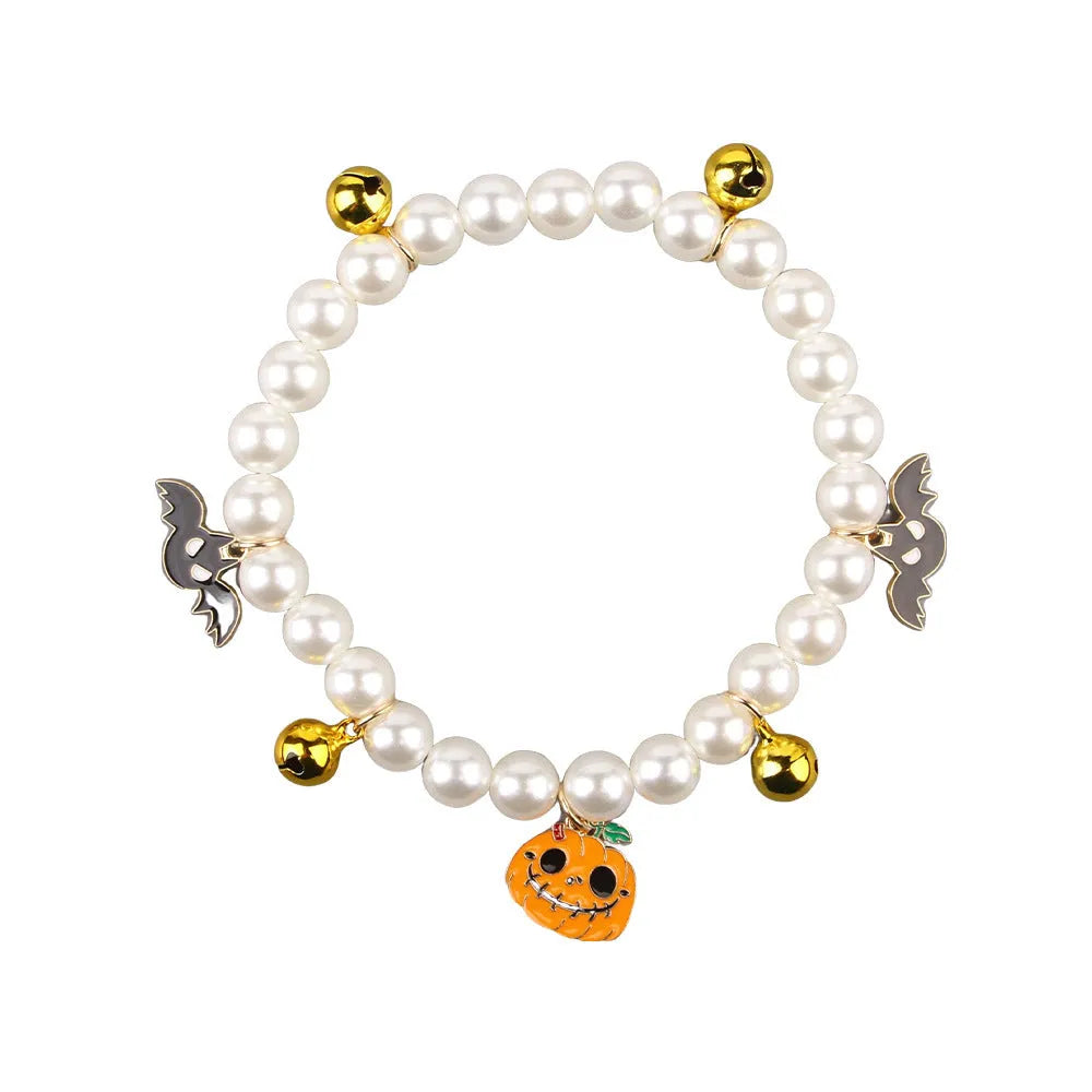 Halloween cat collar with simulated pearl necklace decoration showing pumpkin designs including purple ghost, skull, and smiling pumpkin patterns