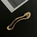 Women's fashion barrettes in zinc alloy with gold and silver finishes showing arc, square, and triangle shapes