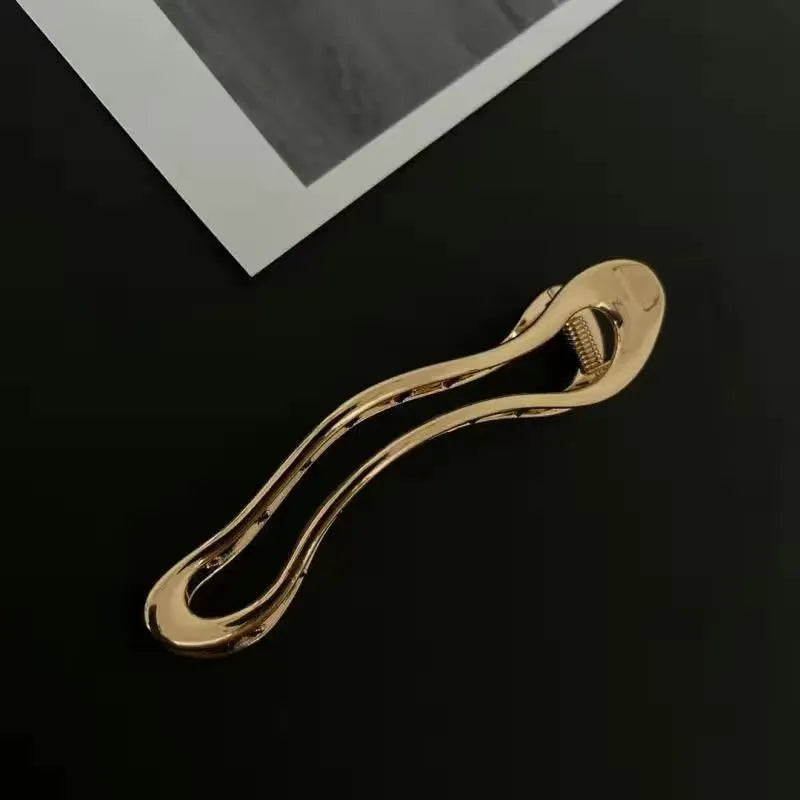 Women's fashion barrettes in zinc alloy with gold and silver finishes showing arc, square, and triangle shapes