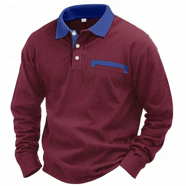 Man wearing a loose-fit dark grey waffle-texture long-sleeved polo shirt with an asymmetric style detail.