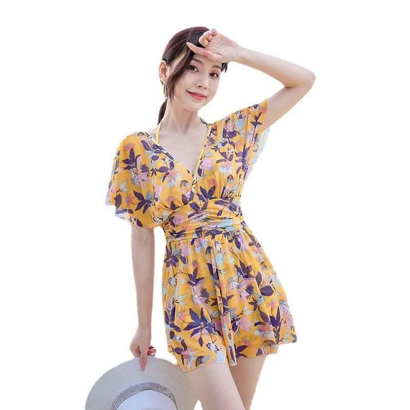 Yellow floral print women's one-piece swimsuit showing front design and polyester fabric construction