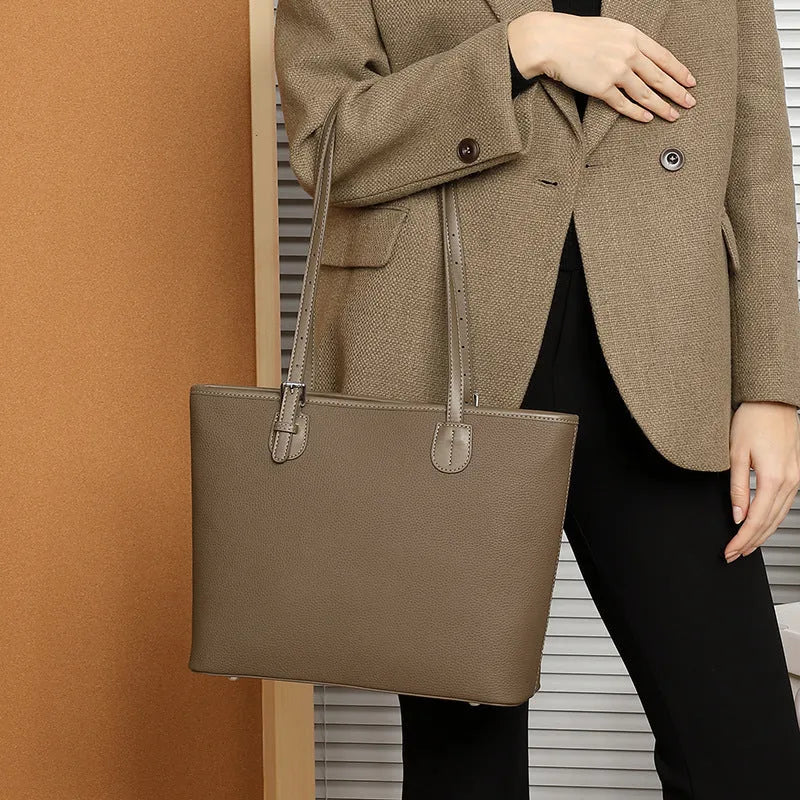 Genuine leather women's retro tote bag in dark grey showing internal zipper and phone pockets