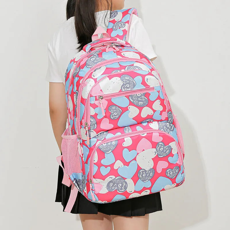 Large blue school backpack with air pillow belt straps on a grey background.