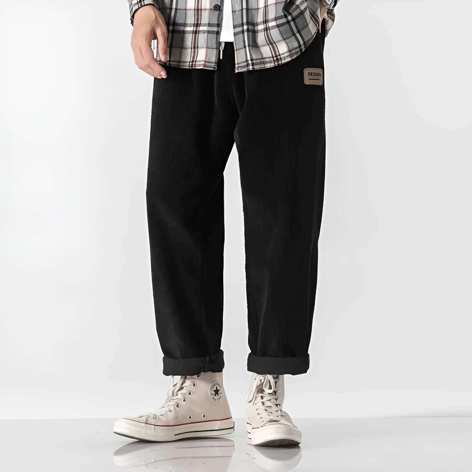 Men's loose straight corduroy sports trousers in army green colour on a hanger