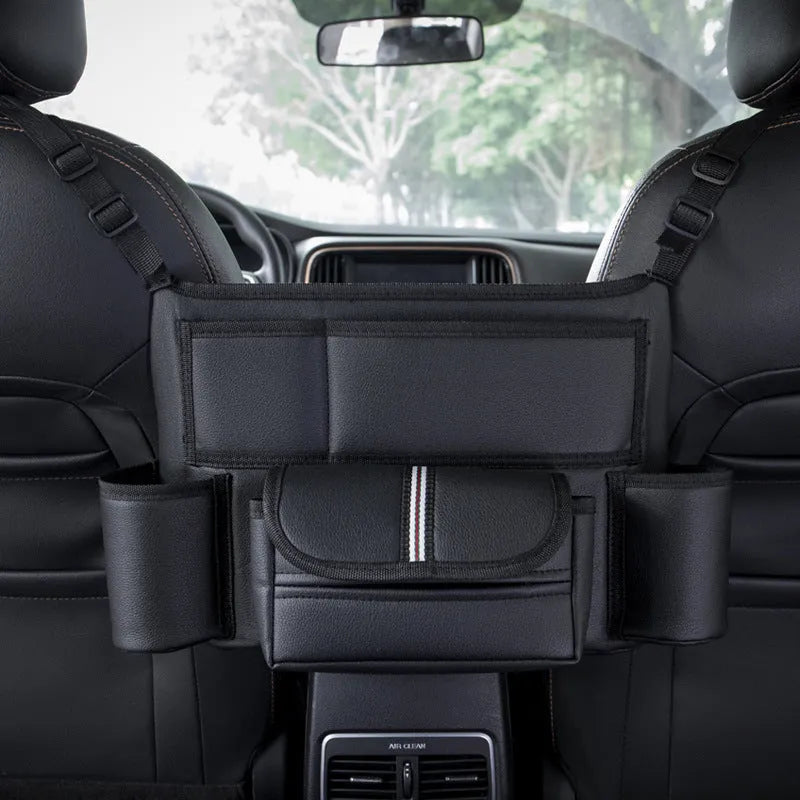 Black leather car seat hanging storage organiser for tissue boxes, shown between vehicle front seats.