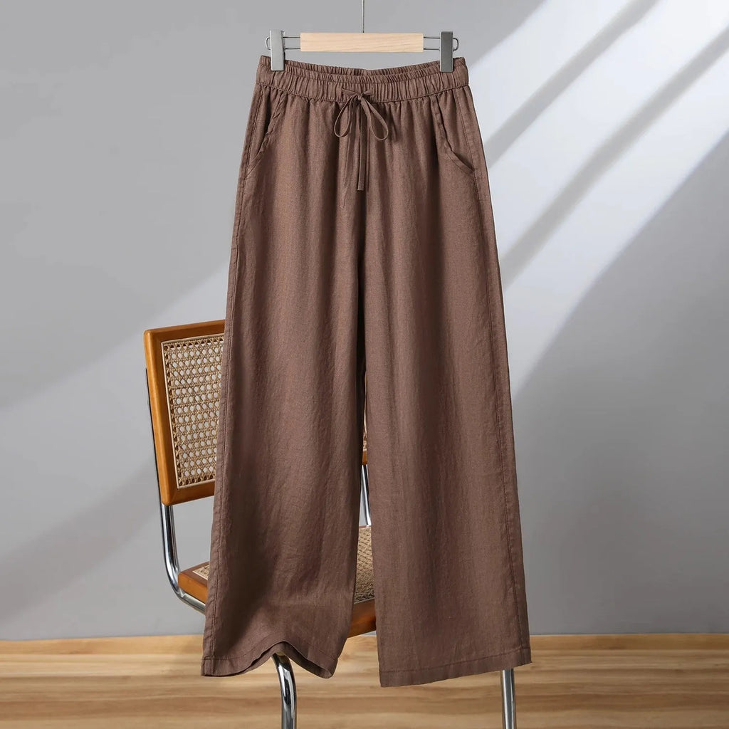 Women's apricot straight-leg casual trousers with elastic waist and drawstring detail laid flat