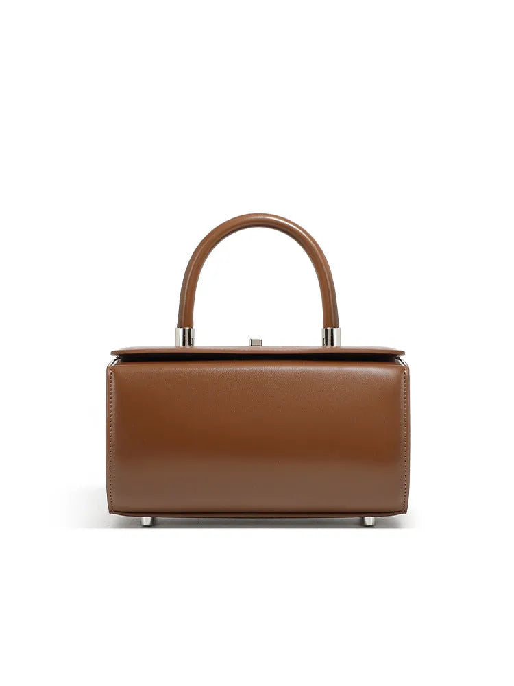 Women's black cowhide leather one-shoulder crossbody bag with clamshell opening, shown closed.