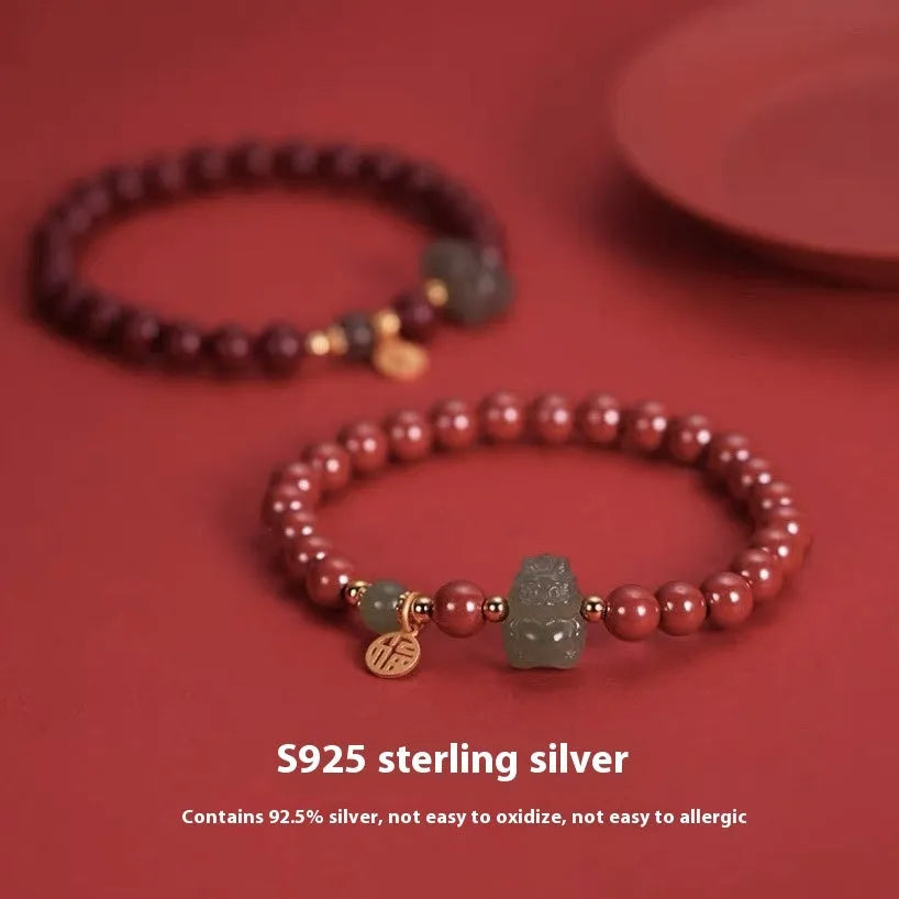 Hetian Jade bracelet with cinnabar accents showing 8mm beads and animal zodiac modelling