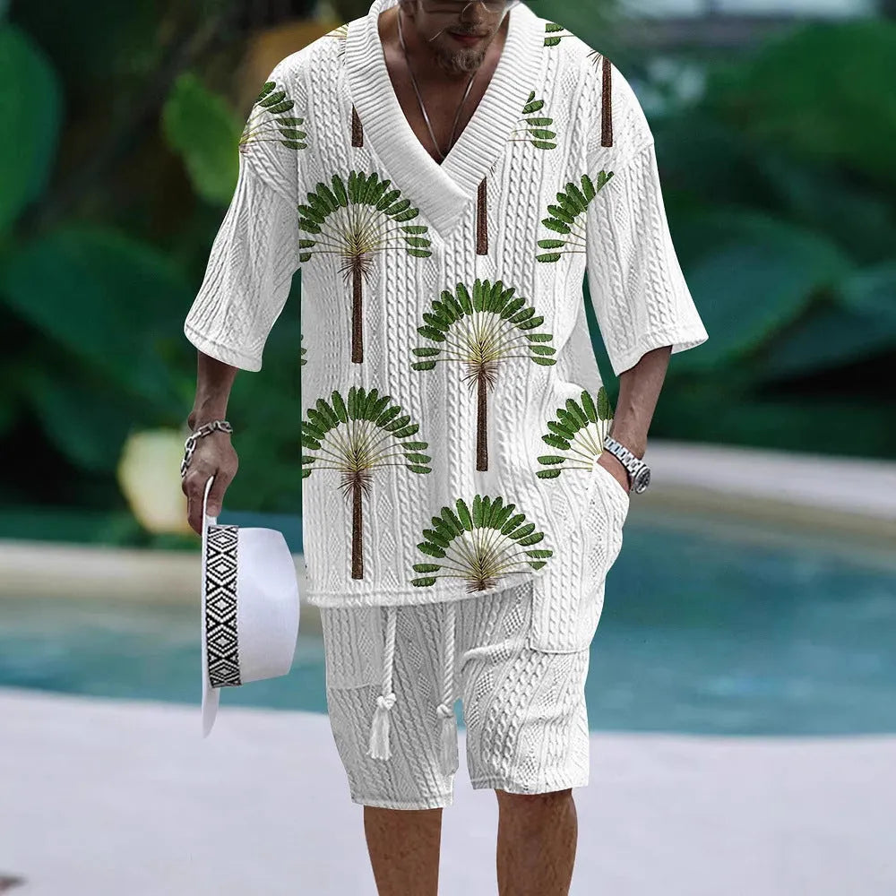 Man wearing a loose fit casual short sleeve suit with matching shorts in a light colour.