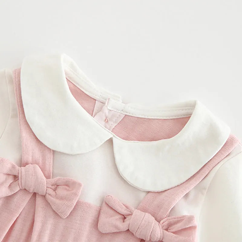 Pink baby girl's embroidered long sleeve cotton jumpsuit on a hanger