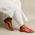 Red women's casual sandals with a square buckle and herringbone toe holder design on a white background