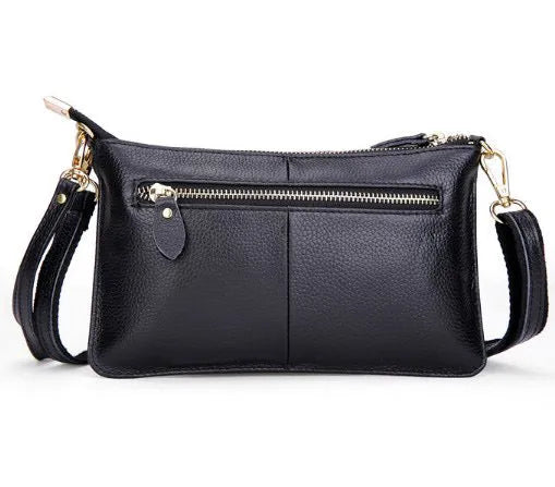 Lady's cowhide slant handbag with a hand strap and long shoulder strap shown in a selected colour.