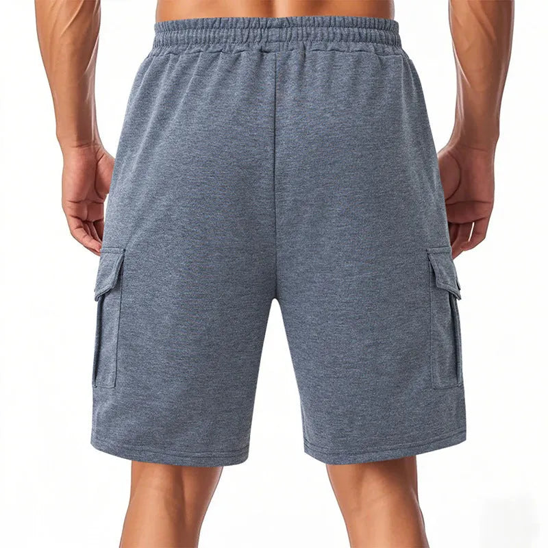 Men's loose grey cargo shorts with multiple pockets, made from textured terry fabric.