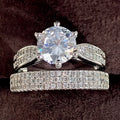 White gold colour alloy geometric wedding ring bracelet with round detail on a hand.
