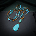 Blue turquoise gem inlaid drop pendant on a long ball bead necklace chain