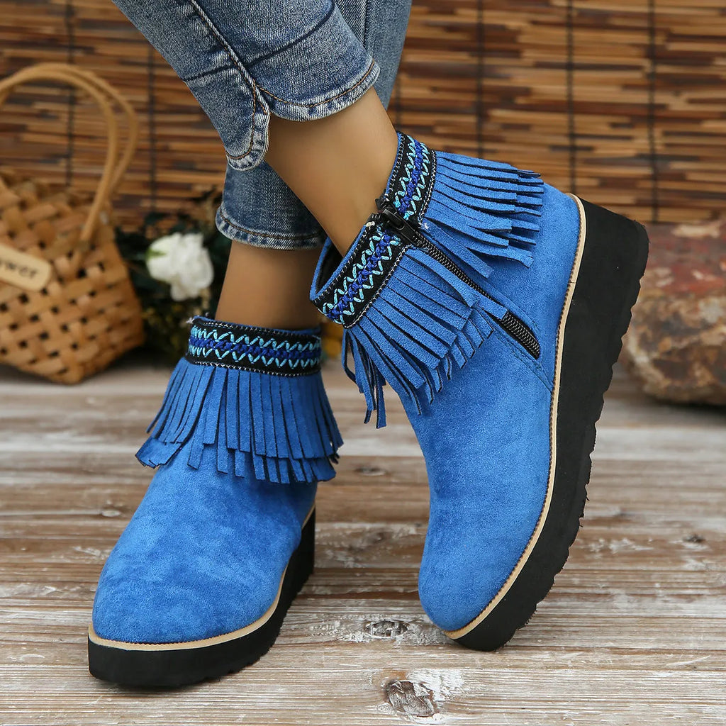 Women's dark brown suede wedge ankle boots with side zip and tassel detail on a thick rubber sole.