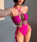 Women's black drawstring waist one-piece swimsuit on a hanger