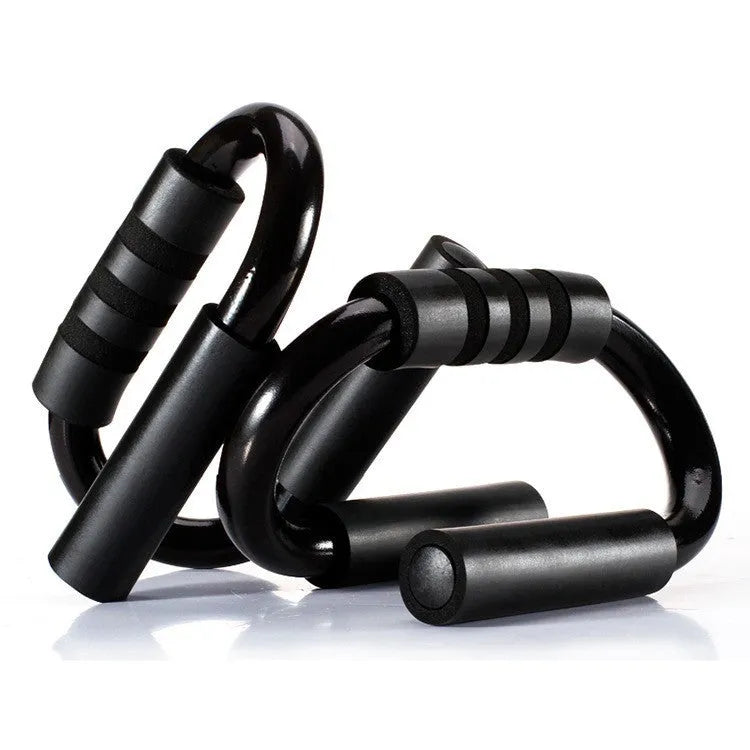 Black S shape push-up bracket rack on a home gym floor