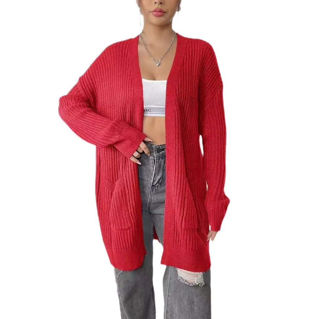 Women's dark green loose fit cardigan with two front pockets and long sleeves.