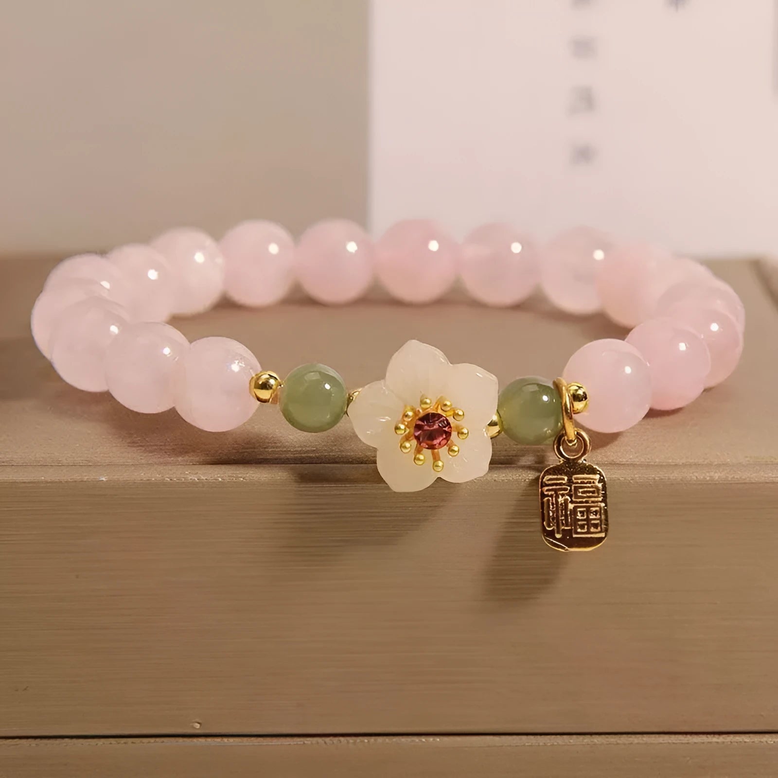 Women's crystal beaded bracelet with Hetian jade style beads, a fruit pendant, and camellia motifs in a blessing card colour.