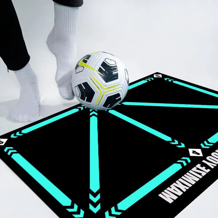 Black rectangular football training mat on grass for skills practice.