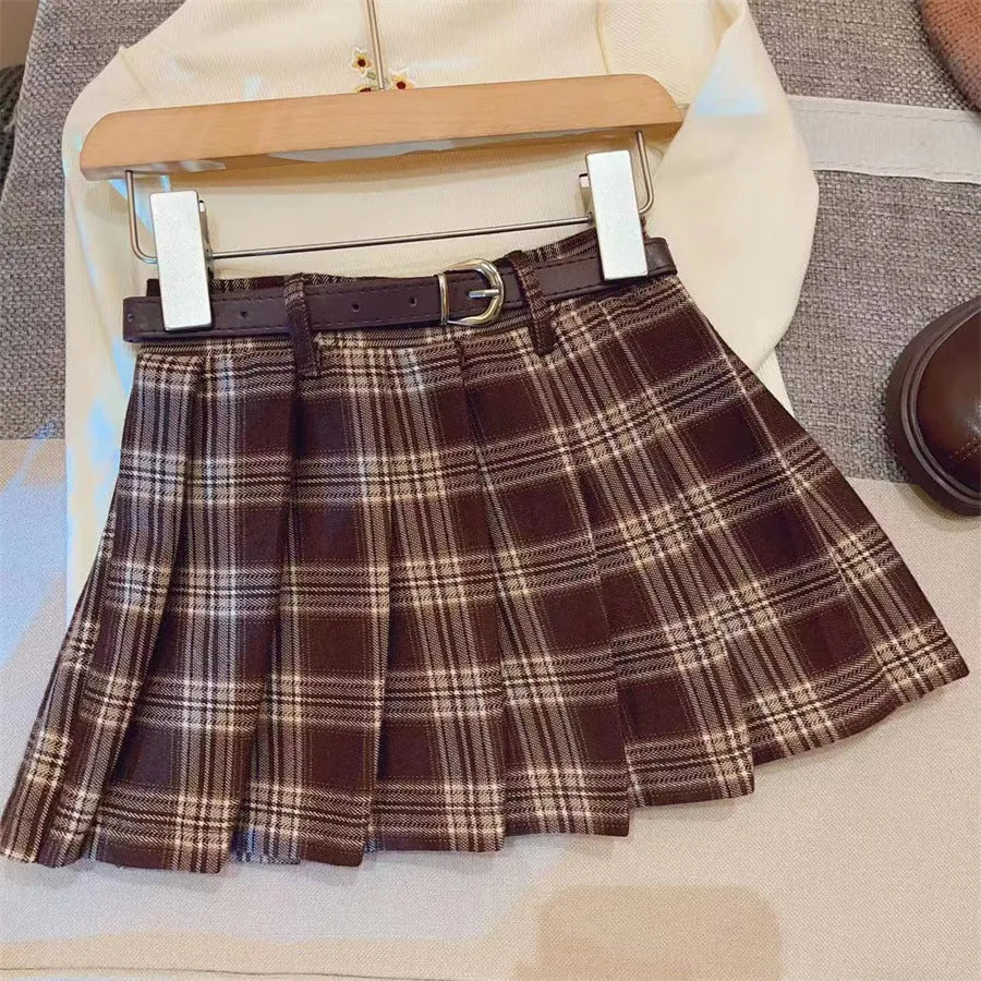 Girls' red and black plaid pleated A-line skirt on a hanger