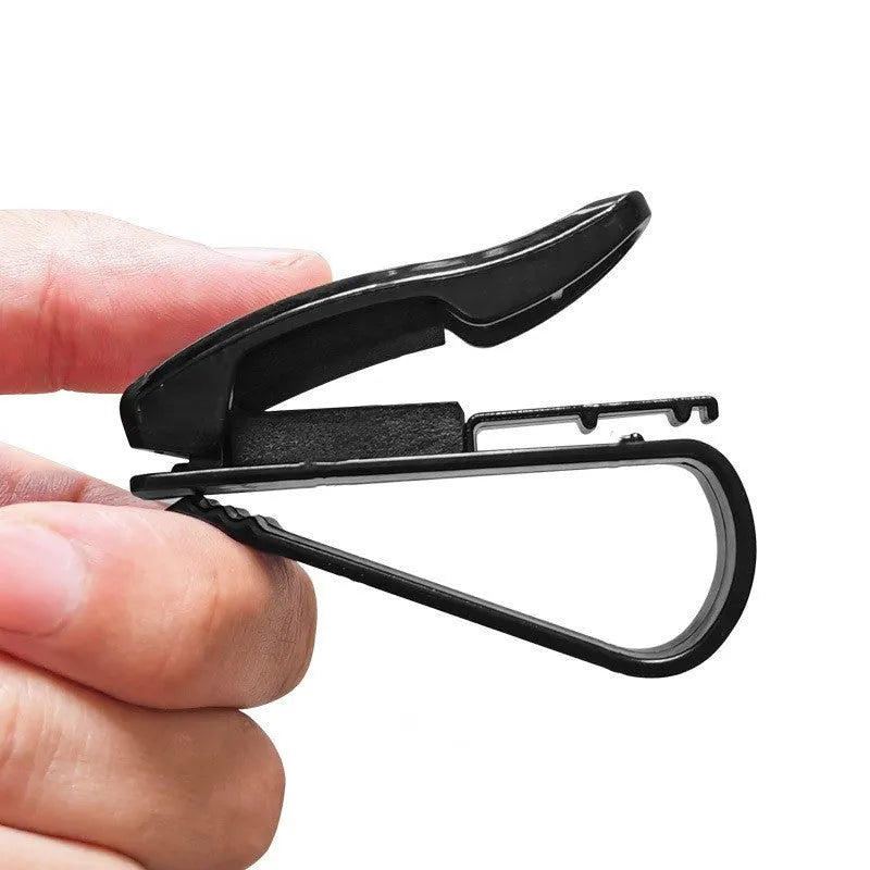 Black plastic car sun visor clip for holding sunglasses, tickets and ID cards.