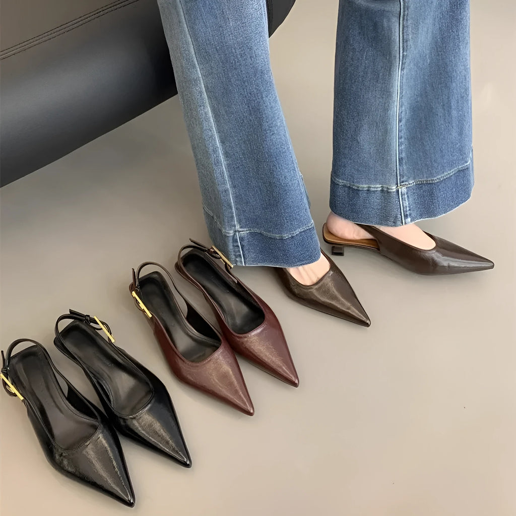 Thin low heel strap pointed leather shoes in black colour showing ankle strap and rubber sole
