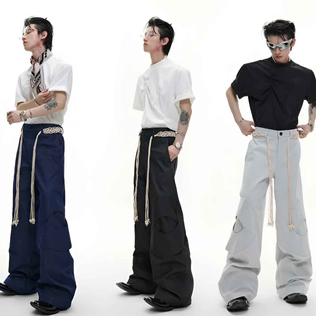 Men's dark blue straight-leg cotton jeans with heavy stitching on the belt and tassel pocket details.