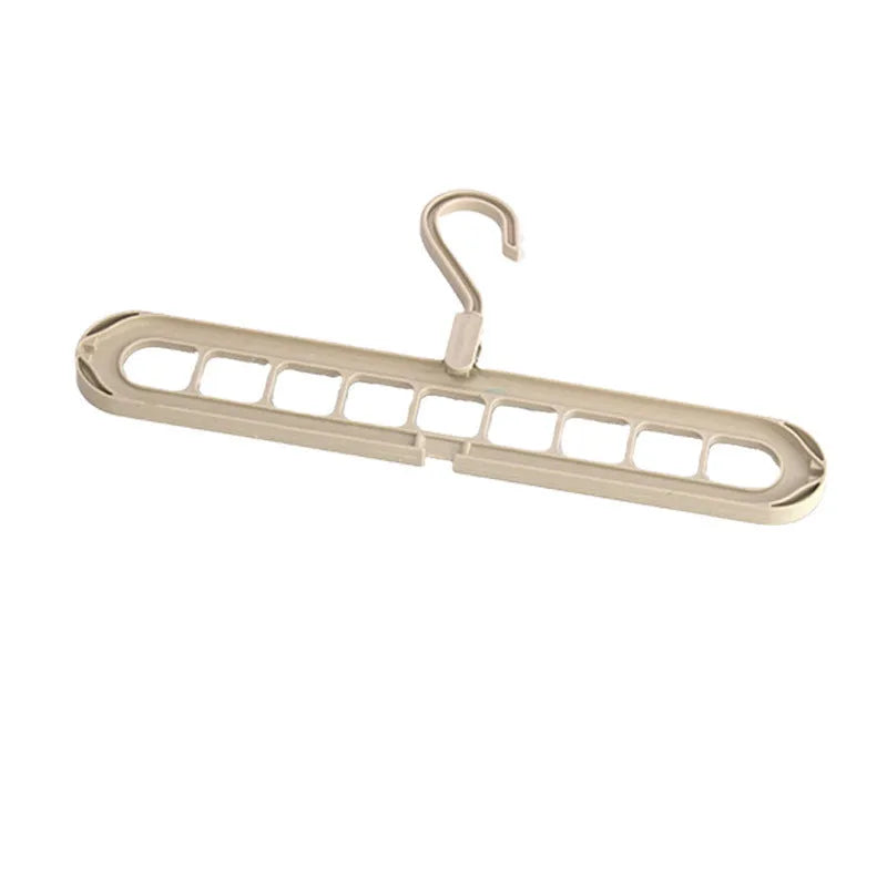 Green plastic multifunctional hanger with nine holes for trousers in a seamless folding pant rack design.