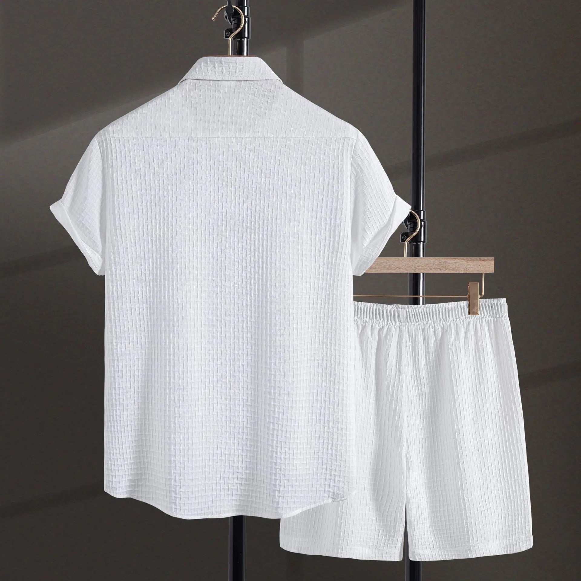 Men's black cotton blend short sleeve shirt and shorts suit set on a hanger.