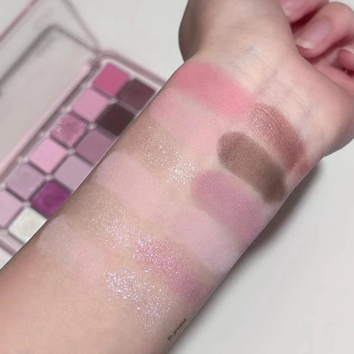 Makeup eyeshadow palette showing twelve different colours in compact case