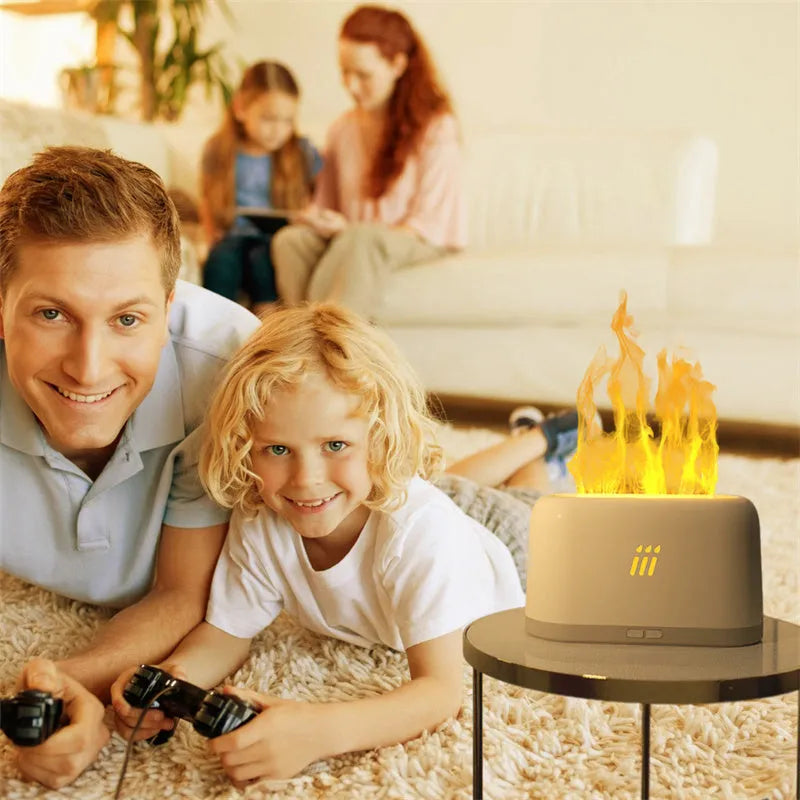Black and white flame aroma diffuser humidifier with LED lights and remote control on a table.