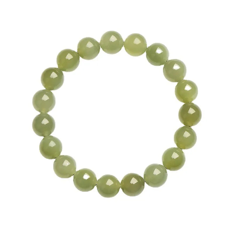 Polished Hetian jade ball bead bracelet in clear colour on wrist, showing spherical beads.